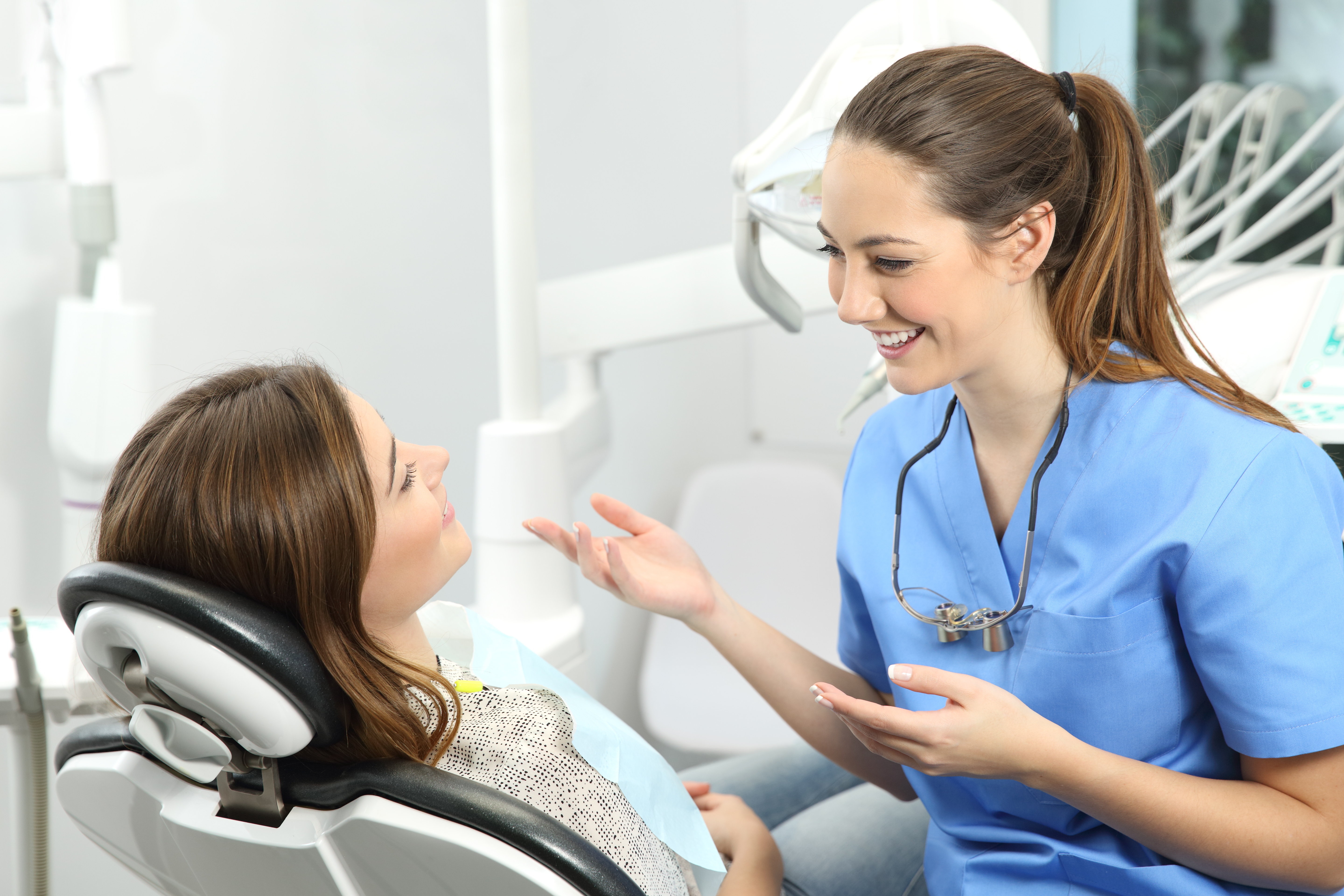 Dental team members collaborating in a bright treatment space