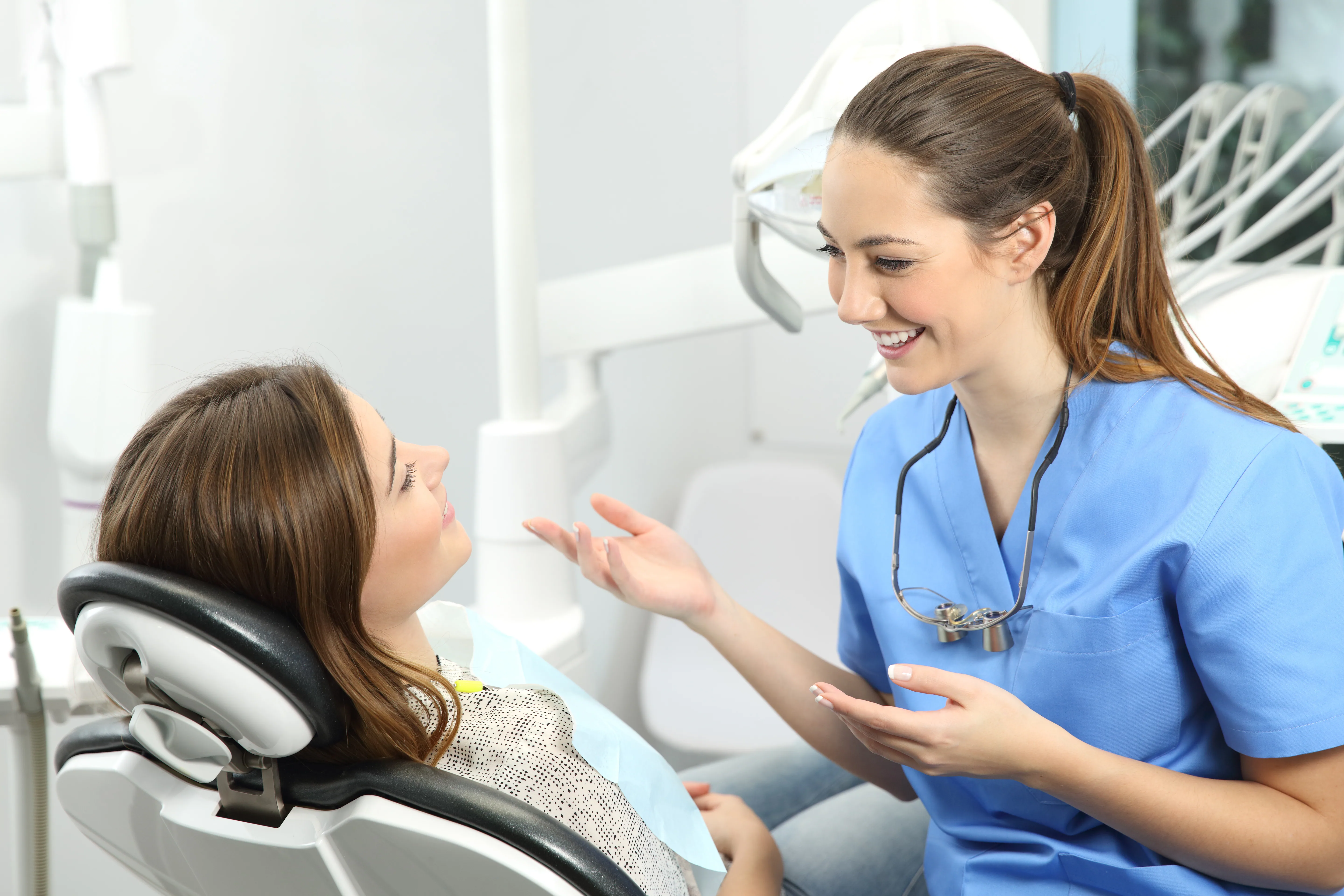 Dental team members collaborating in a bright treatment space