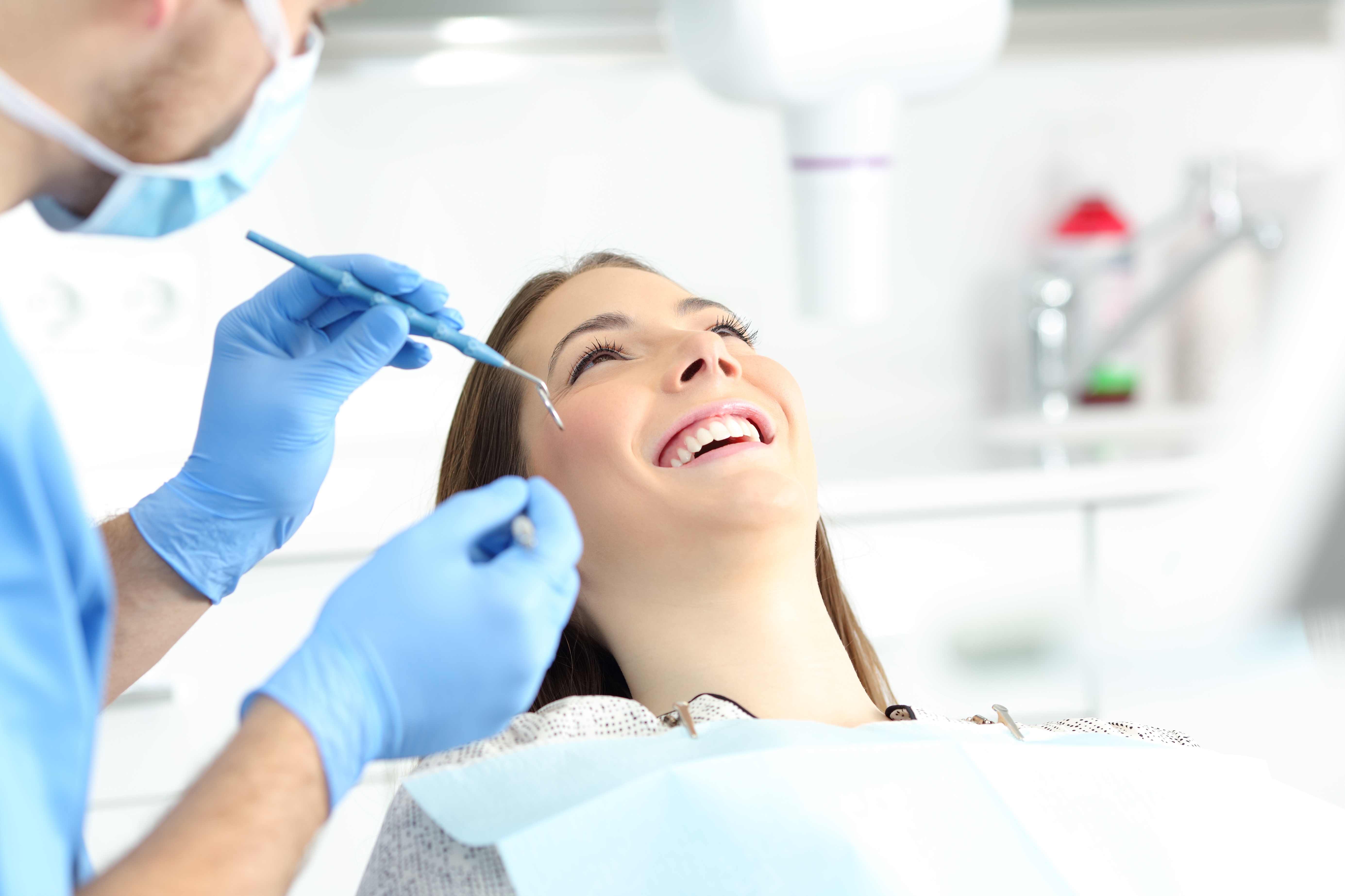 Dental professional performing a careful oral examination