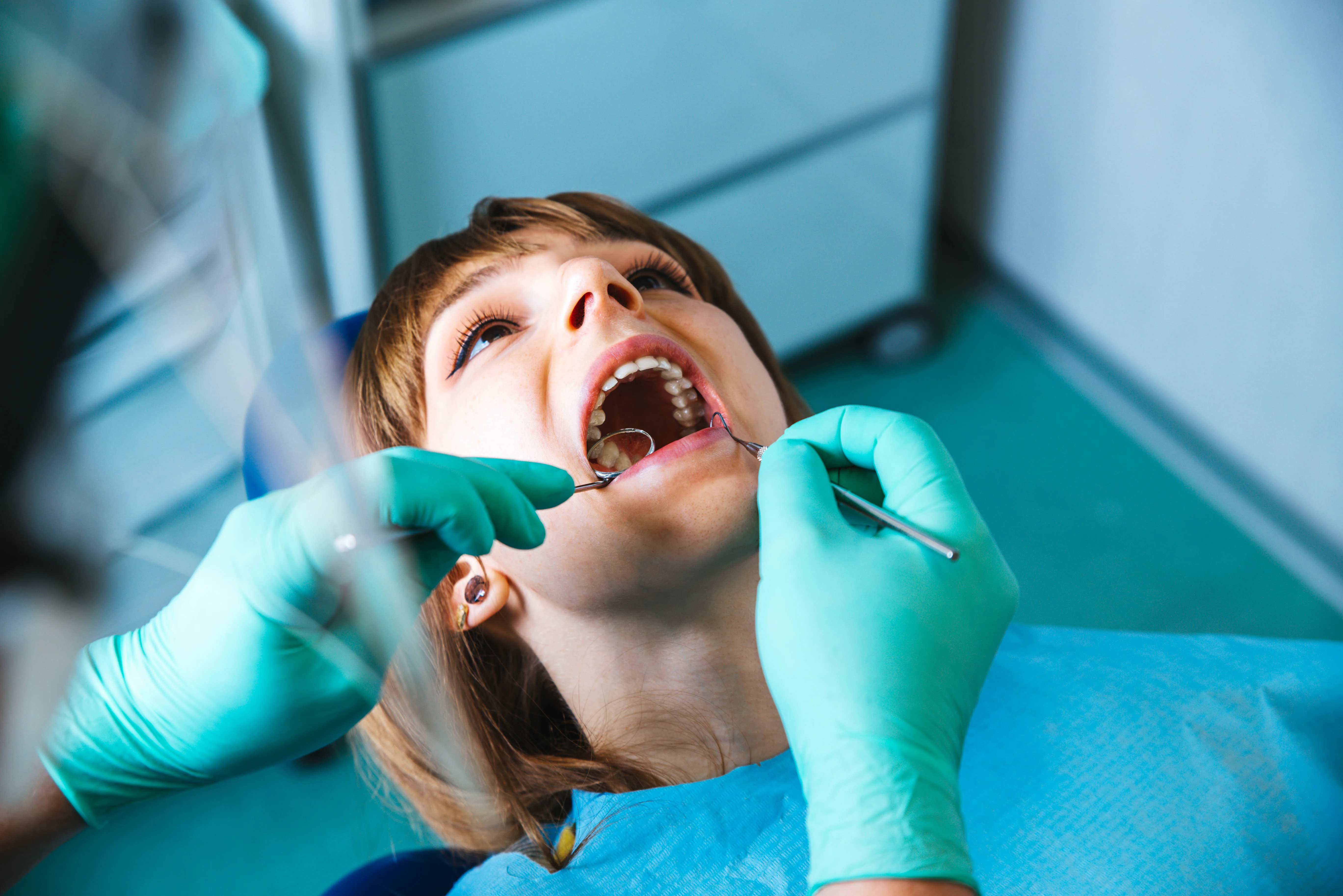 Dental professional examining a patient with an urgent concern